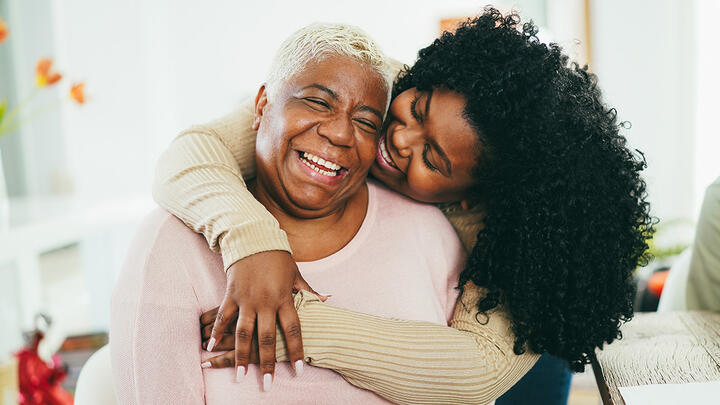 Mother and daughter hugging and laughing